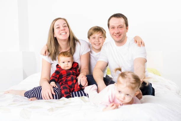 istock five member Young Family Having Fun In Bed 850941076