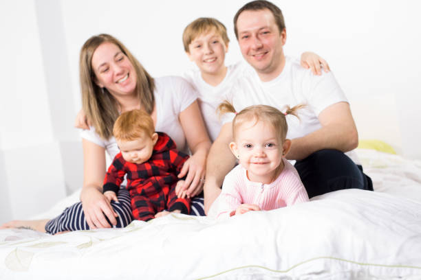 istock five member Young Family Having Fun In Bed 850941190