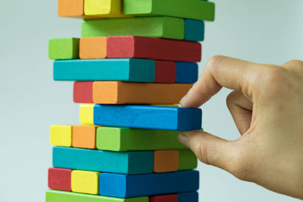 istock Risk or stability concept  with hand pulling colorful wooden block from the tower 850941286