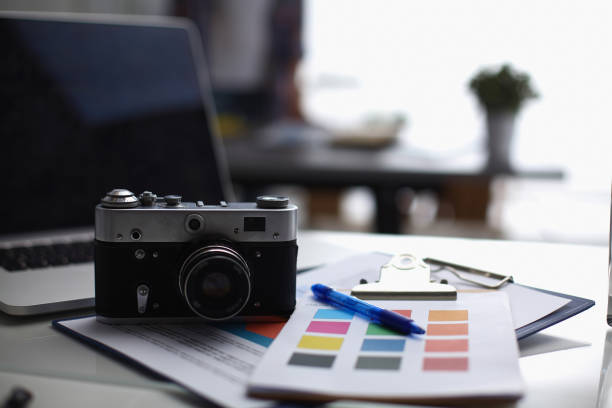istock Laptop and camera on the desk with folder 850941876
