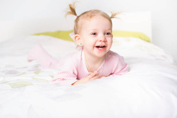 istock two year old blond girl in bed at home 850942020