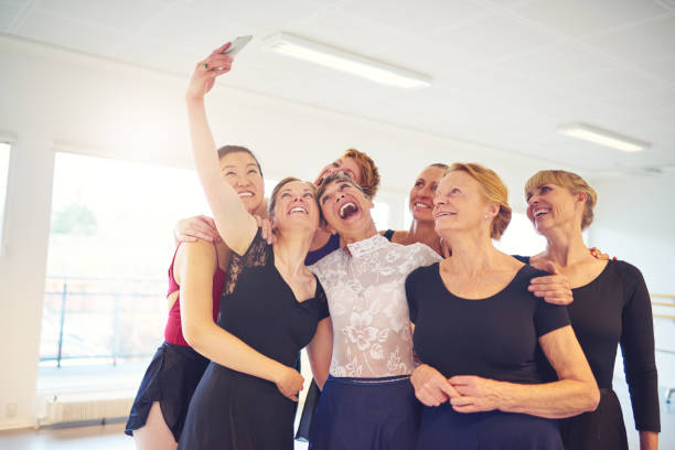 istock Group of laughing women taking selfies in a dance studio 850943372