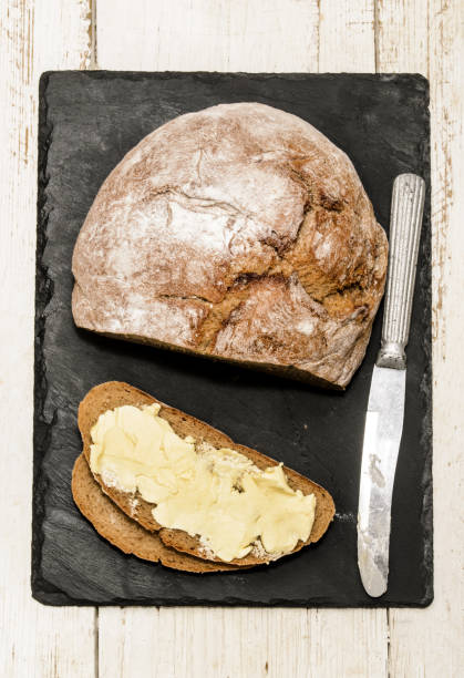 istock home baked and sliced, buttered bread on a slate 850947164