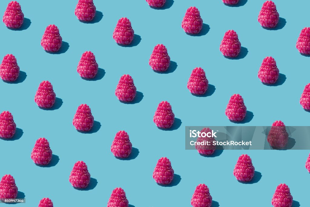 Food pattern Raspberry on a blue background Colored Background Stock Photo