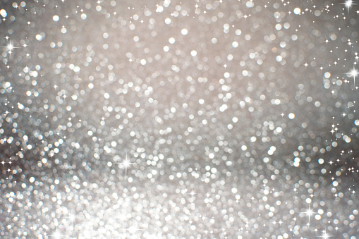 gray silver Lights Festive background. Abstract holiday twinkled bright background with natural bokeh defocused white lights. Party abstract background.