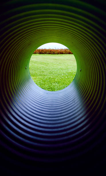 istock Denmark: View through a green plastic tube on a playground 850957632