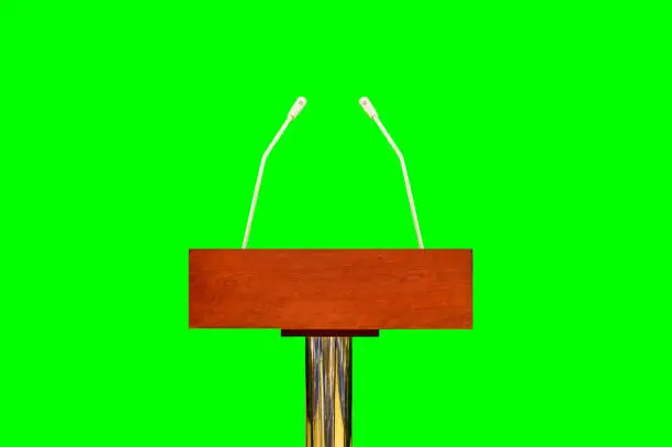 An empty podium and microphones isolated cutout on green background with chroma key