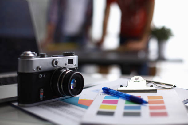 istock Laptop and camera on the desk with folder 850959906
