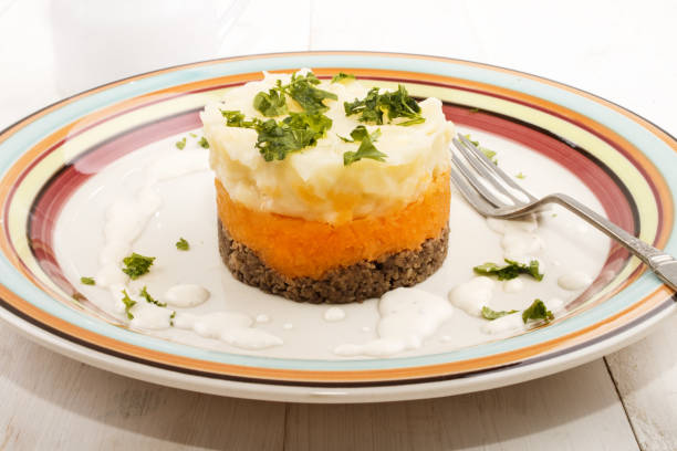 haggis with mashed potato and turnips on a plate haggis, a very scottish dish, with mashed potato, turnips and parsley on a plate haggis stock pictures, royalty-free photos & images