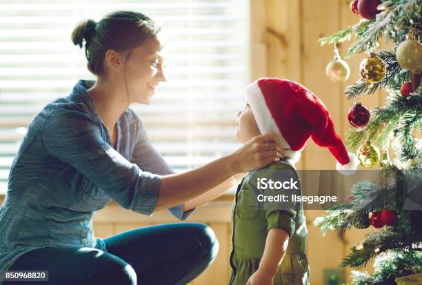 Holiday Season Family Decorating The Christmas Tree Stock Photo - Download Image Now