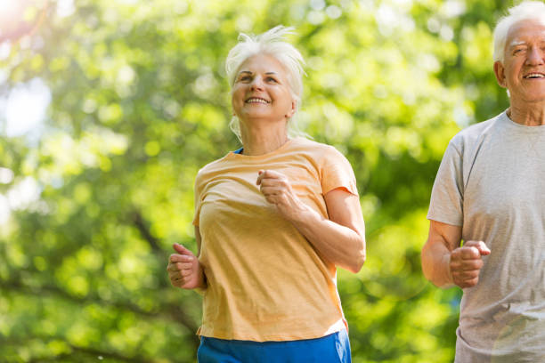 istock Senior couple running in park 850974478