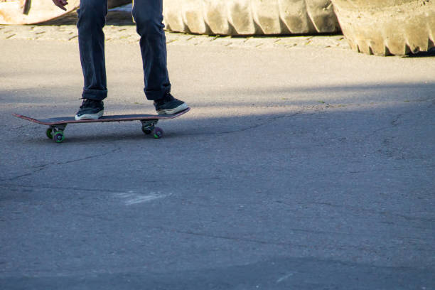 istock Skateboarder legs riding skateboard at skatepark 850974514
