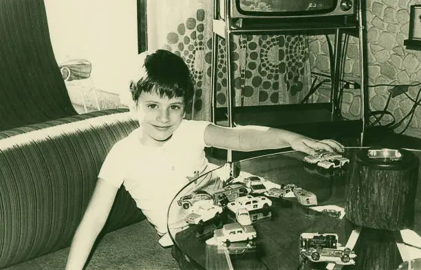 Photo of Vintage boy playing with toy cars