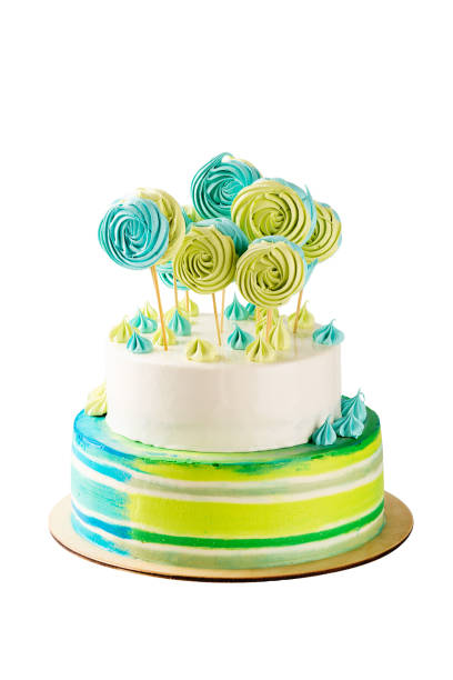 istock Tiered green and blue birthday cake isolated on white 850978408