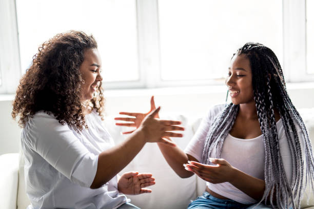 istock affectionate friends afro american sitting on sofa 850981788