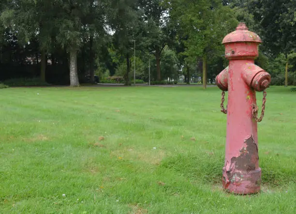 Ancient red firepump as decoration in a park in Venray, Holland