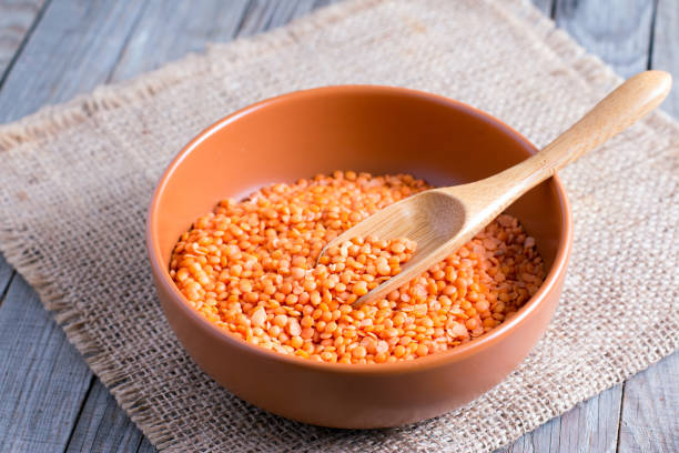istock Red lentils in a ceramic bowl on a wooden background 850986860