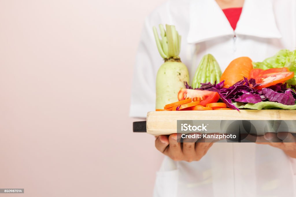 Nutrition healthy diet food care vegetables. Nutritionist standing holding a tray of healthy vegetables recommended to consumers. Care Stock Photo