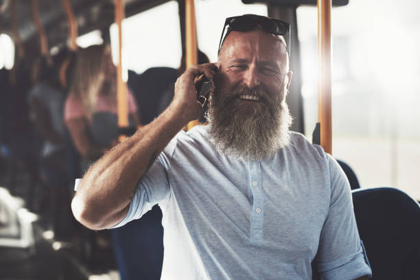 istock Laughing man standing in a bus talking on the phone 850993182