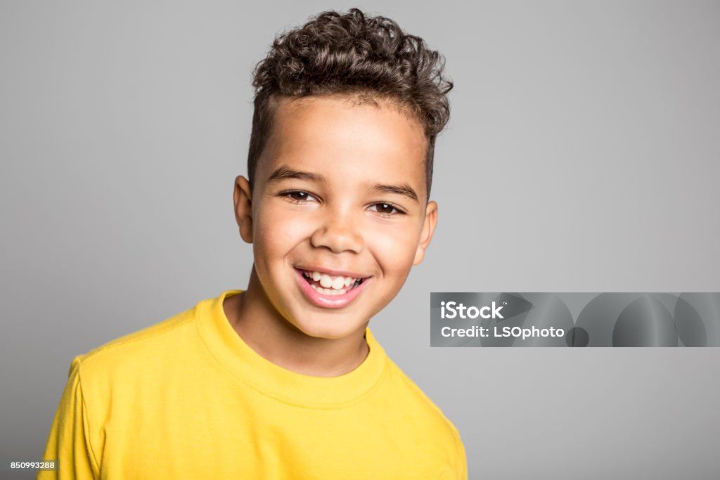 Adorable african boy on studio gray background An Adorable african boy on studio gray background Boys Stock Photo