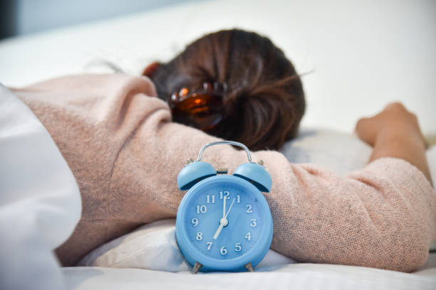 istock Sleepy Asian woman with Alarm clock. 850995692