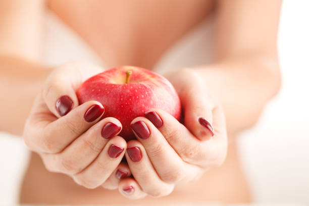istock Attractive Female Holding Fruit Food Apple in Manicured Hands 850999914
