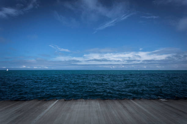 istock Grey lines leading to blue water and grand sky 851000090