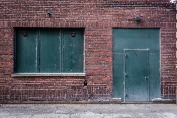 istock Green window and door on a red brick wall 851000242