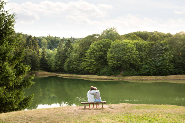 istock Senior couple on a walk at the lake hugging. 851000376