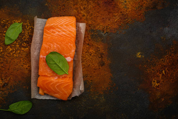 istock Raw fresh salmon steak with spinach lieaves 851003726