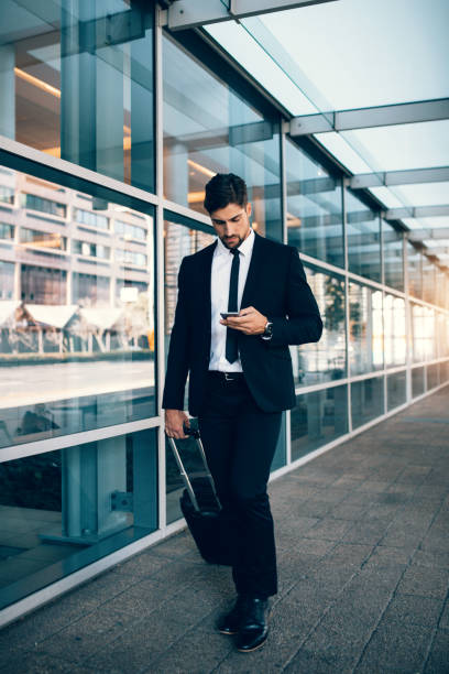istock Handsome businessman using mobile phone at airport 851007214