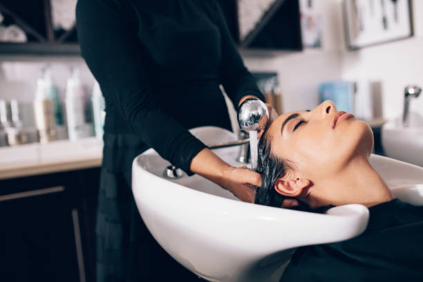 istock Woman getting hair wash done at salon 851007880