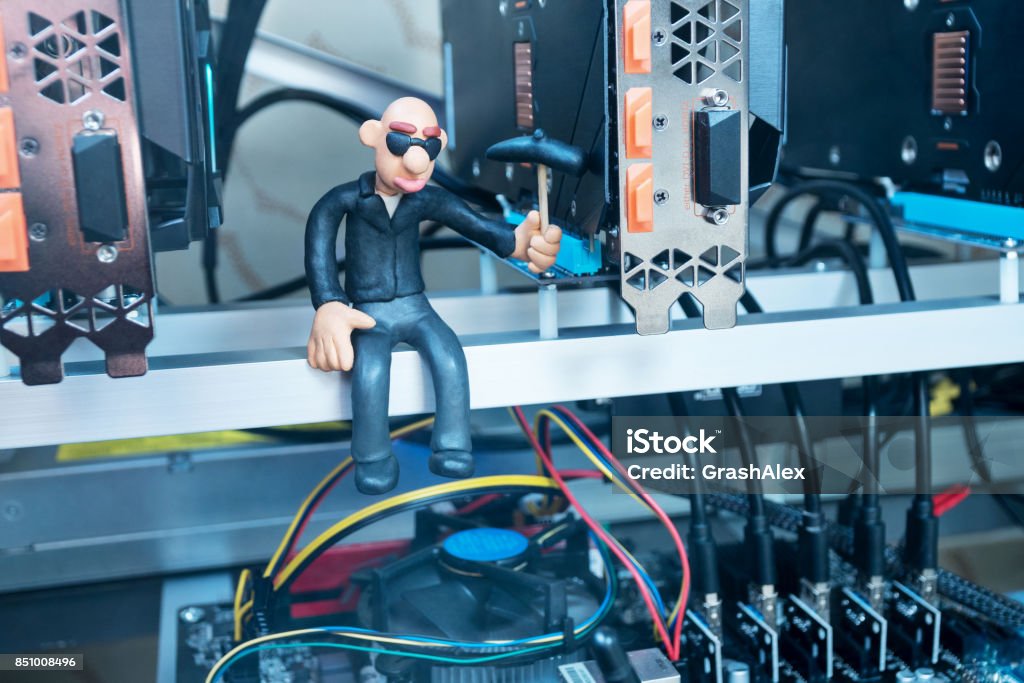 Extraction of crypto currency from video cards Bald plasticine man knocks on the video card pick for mining cryptocurrency Bit - Binary Stock Photo