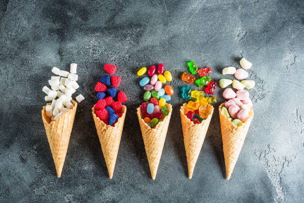 istock Assorted colorful candy in waffle cones. Summer concept. Flat lay, top view 851008800