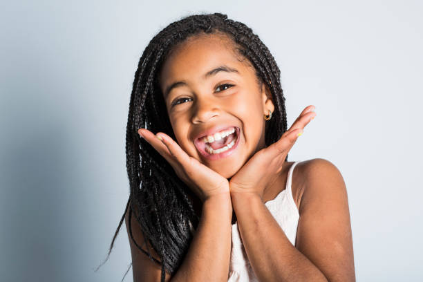 Adorable african little girl on studio gray background