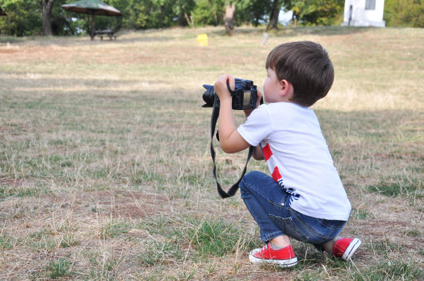 istock Four years old boy taking photos with camera. 851011864