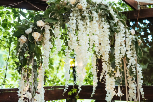 istock Wedding arch decorated with hanging flowers 851015952