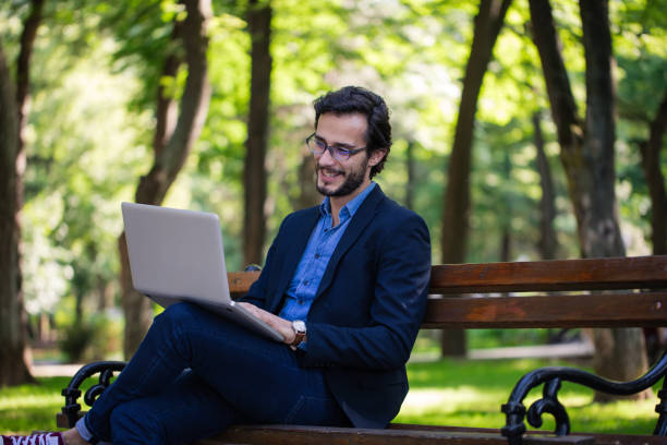 istock Businessman works in park 851016056