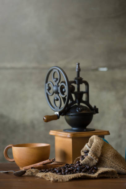istock Vintage manual coffee grinder with coffee beans and cup 851021590
