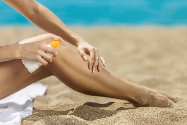istock Woman applying sun protection cream at beach 851021616