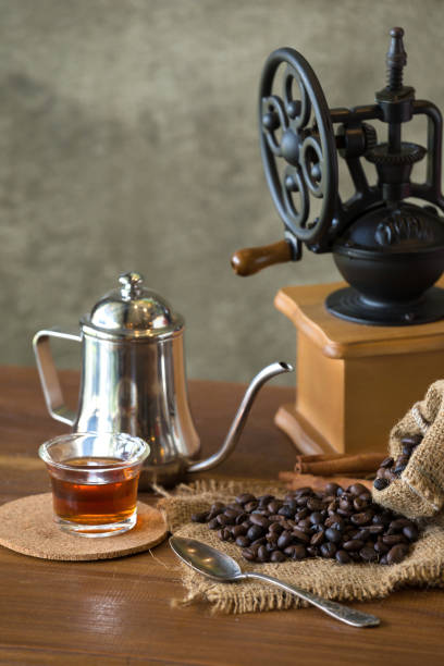 istock Vintage manual coffee grinder with coffee beans and cup 851021638