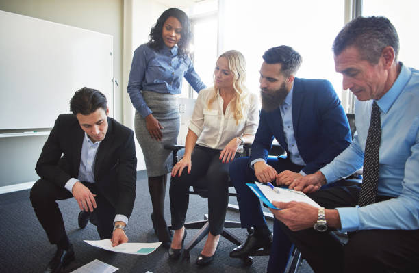 istock Group of businesspeople planning with paperwork in an office 851025330