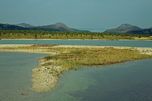 A sandbar and the island on the lake. Lake Momontay, Magadan region.