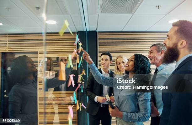 Cheerful Entrepreneur Team Talking In The Office Stock Photo - Download Image Now - Leadership, Teamwork, Business