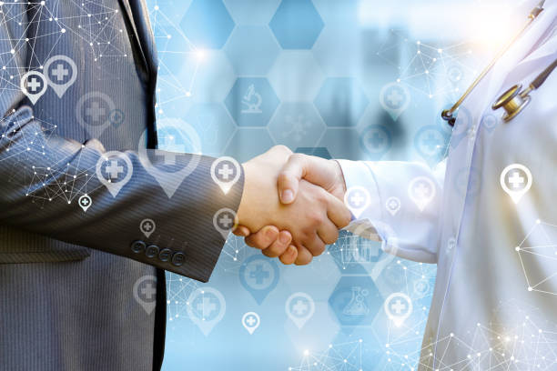 Doctor shakes hands with patient .