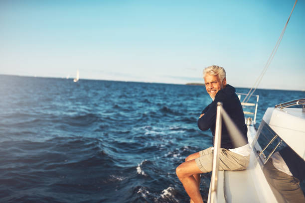istock Mature man enjoying the ocean view from his sailboat 851031006