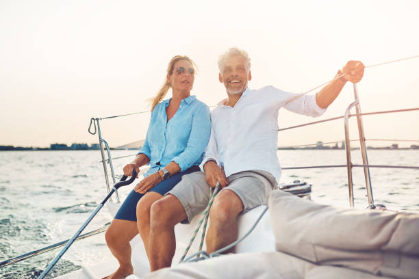 istock Smiling couple sailing their boat together on a sunny afternoon 851031286