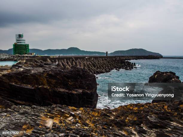The Charming Of Nature Where The Black Stone Is Polished And Turn Into Yellow By The Sea Water Hitting Them For Long Period Of Time The Pier Is Also Peaceful To Enjoy The Moment Of The Beach Stock Photo - Download Image Now