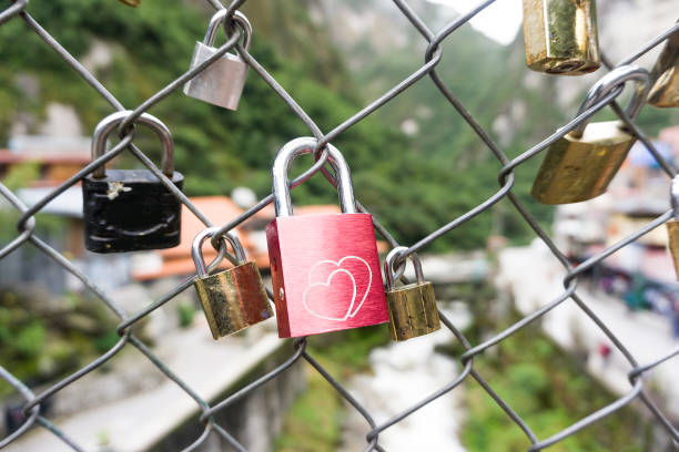 istock Red heart shaped lock padlock on the fence on the background 851041316