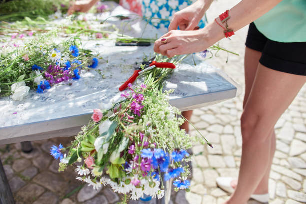 istock Learning flower arranging, making beautiful bouquets with your own hands. Master class on making bouquets. Made. Manufacturer summer wedding bouquet 851042594